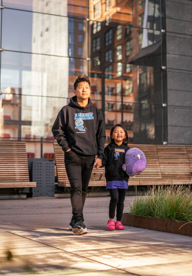 Father and daughter both feeling comfortable in their hoodies.