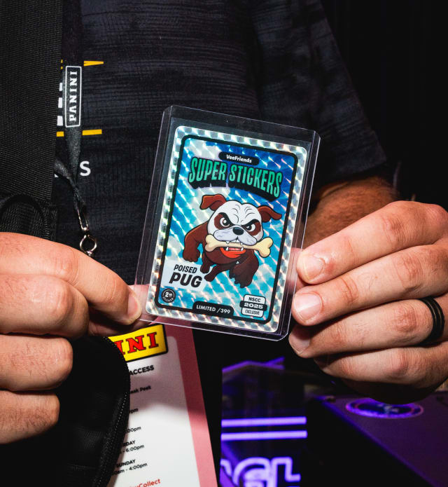 A VIP at The National holding their Poised Pug /399 Super Sticker.